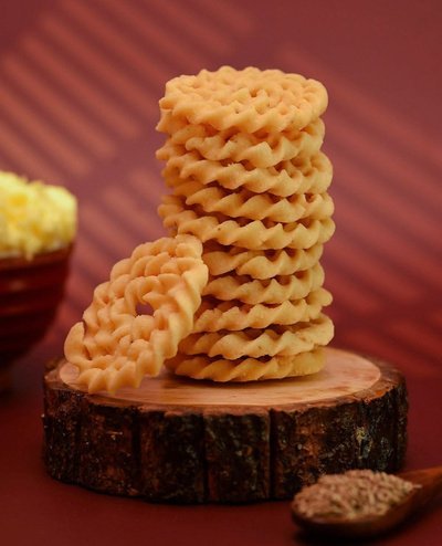 A platter of Indian snacks being shared by hand